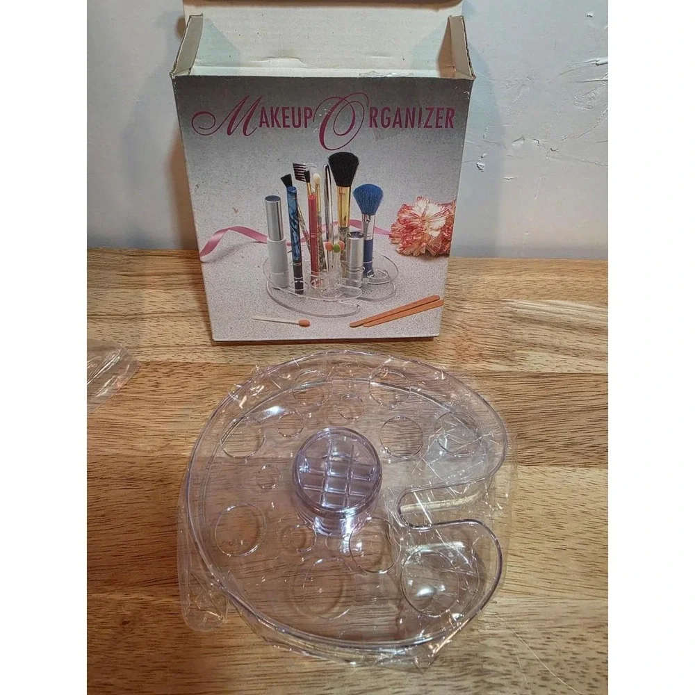 1990s NOS clear acrylic makeup organizer featuring tiered slots for holding